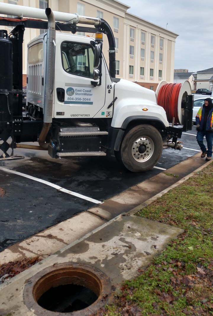 Storm-water-drainage-truck-pulled-up-to-fix-commercial-storm-drain-in-Virginia.